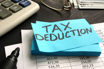 “Tax deduction” text on a blue sticky notes